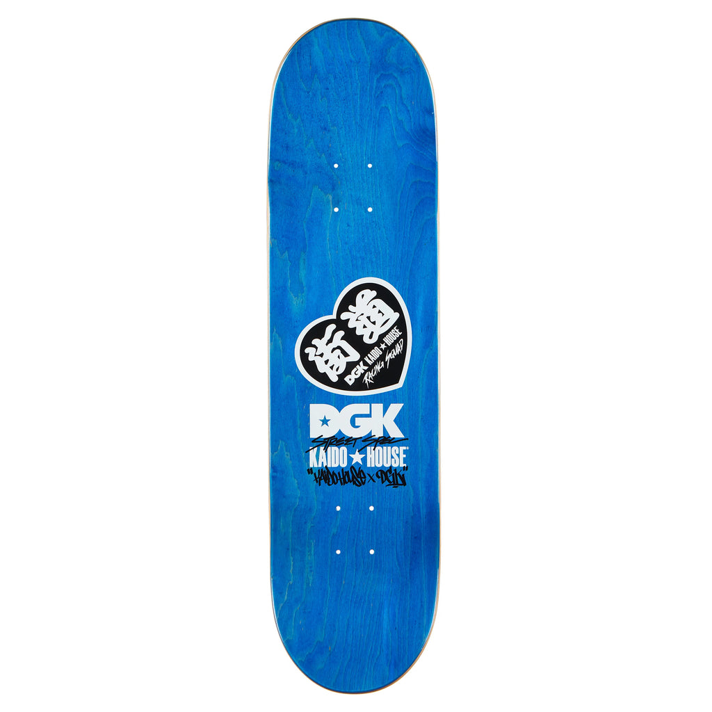 The DGK X Kaido House Konbini Holographic Multicolor skateboard deck features a blue base with black and white stylized graphics, showcasing DGK and Kaido House logos. It's 8.25" wide and has Zokusha Rainbow Glitter accents for added flair.