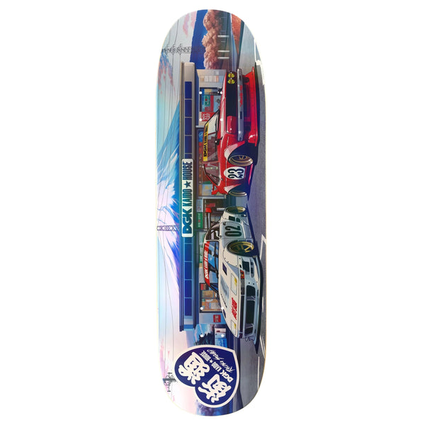 The DGK X KAIDO HOUSE KONBINI HOLOGRAPHIC MULTICOLOR SHAPED skateboard deck features durable maple wood, a vibrant scene of a gas station and race cars, Japanese text for authenticity, and holographic elements that bring it to life.