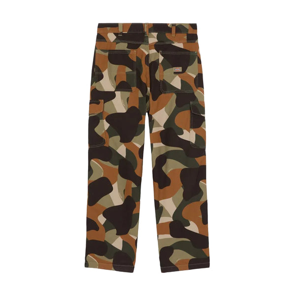 The DICKIES Camo Print Duck Cargo Pant in Imperial Green, made by DICKIES, is crafted from durable cotton canvas and features a brown, green, and black pattern. It includes multiple pockets and reinforced knees and is displayed from the back on a white background.