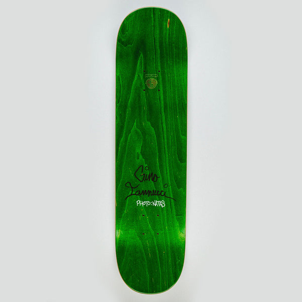 The FUCKING AWESOME GINO 1993 skateboard deck features a green wood grain finish, black signature, and “PHOTO-NY03” text on the bottom half.