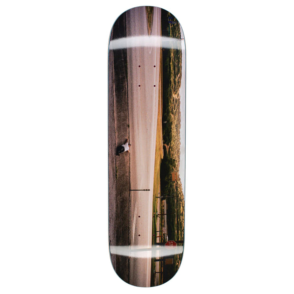 An artful skateboard featuring FUCKING AWESOME DYLAN PHOTO BY DILL's picture and various stains.