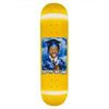 The FUCKING AWESOME X SICKID K.B. CLASS PHOTO skateboard deck features a smiling child in a blue graduation cap and gown, with "Fucking Awesome" printed below the portrait on a striking yellow background.