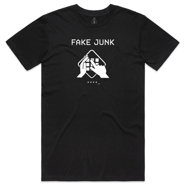 The FAKE JUNK PROTECT TEE BLACK, from the FAKE JUNK brand, is crafted from soft combed cotton and features white text that reads "FAKE JUNK PROTECT" above an illustration of hands rearranging tangible objects.