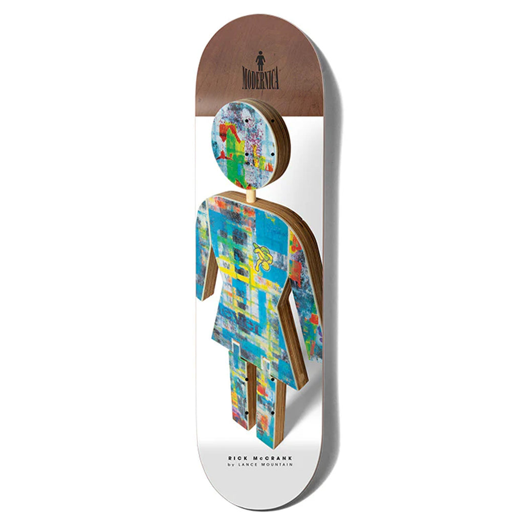 The GIRL MODERNICA McCRANK X MOUNTAIN skateboard showcases a dress silhouette design with abstract patterns and the word "Modernica." Inspired by Ed Templeton's unique artwork, it blends style and contemporary flair seamlessly.