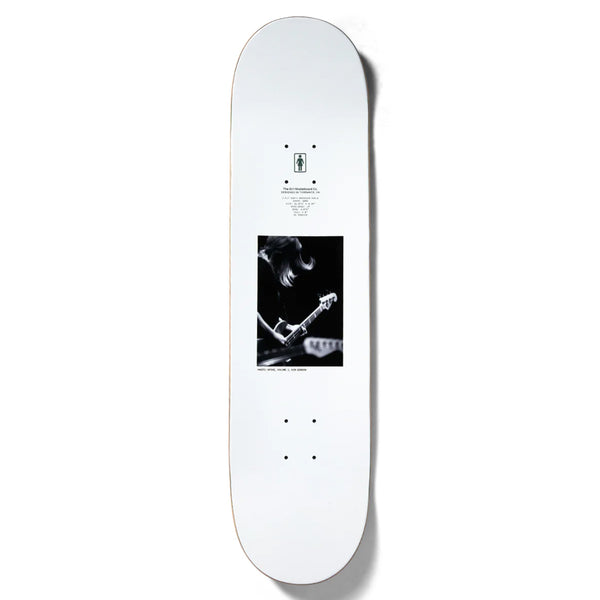 Introducing the GIRL SPIKE PHOTO KIM GORDON skateboard deck by GIRL, measuring 8.25" x 31.75". It features a black and white image of a person playing a guitar in the center, while the rest of the deck remains blank white with subtle text and graphics near the top.