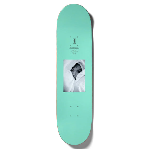 A teal skateboard deck, with dimensions perfect for any skater, features a black-and-white image of a person partially covered by a blanket printed in the center. This product is the GIRL SPIKE PHOTO BJORK by GIRL.