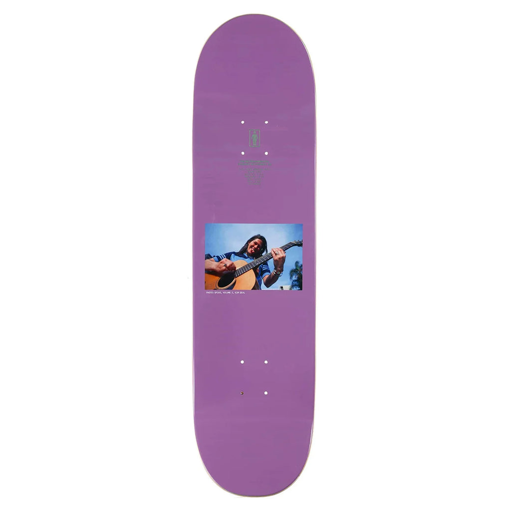 A purple GIRL skateboard deck with a photo of a girl playing an acoustic guitar printed on it, named GIRL SPIKE PHOTO KIM DEAL.