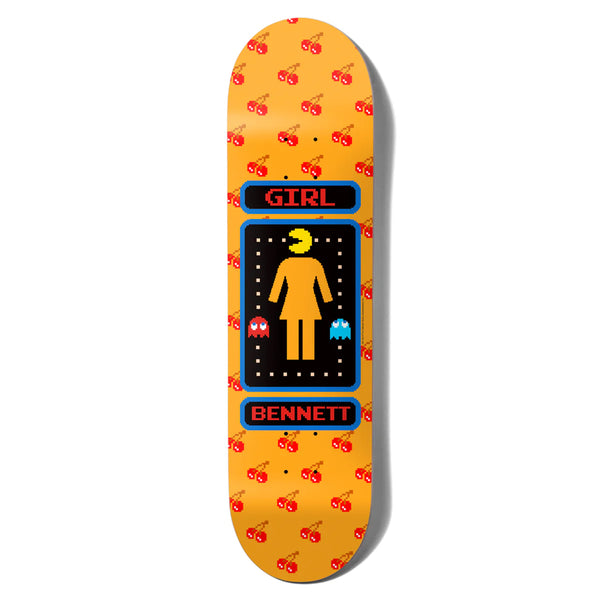 The GIRL X PAC-MAN BENNETT skateboard deck by GIRL showcases an orange background with a central graphic of a female icon, GIRL X PAC-MAN elements, and "Girl Bennett" text. The deck is also adorned with cherry patterns.