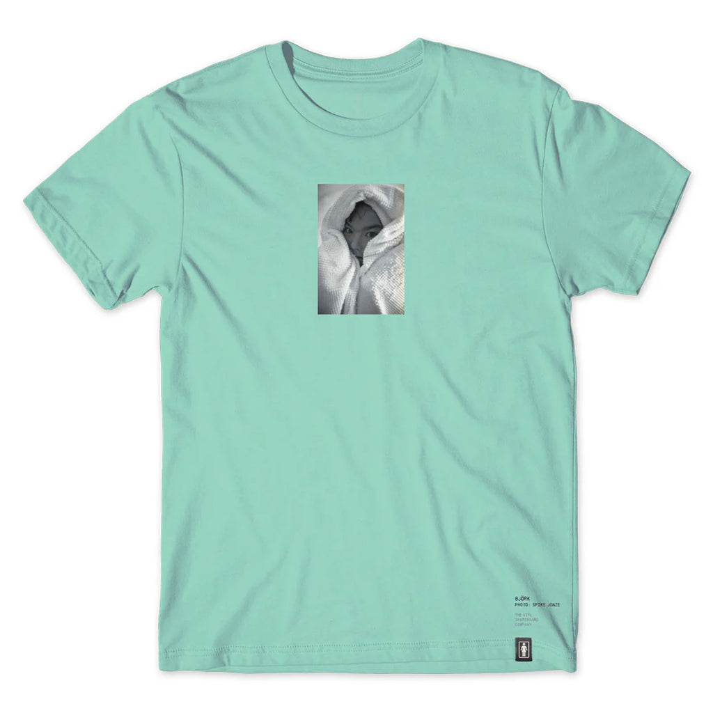 A light turquoise t-shirt featuring a small central image of a person’s partially concealed face wrapped in a blanket, crafted from Ring Spun US Cotton for comfort and durability. The CRAILTAP GIRL SPIKE JONZE BJORK PHOTO TEE MINT ensures you stay stylish while feeling at ease.