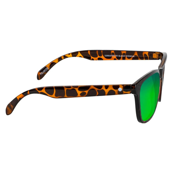 A pair of GLASSY sunglasses with a matte black tortoiseshell frame and green mirror lenses, branded with the text "sun haters by GLASSY eyewear" on the arms.