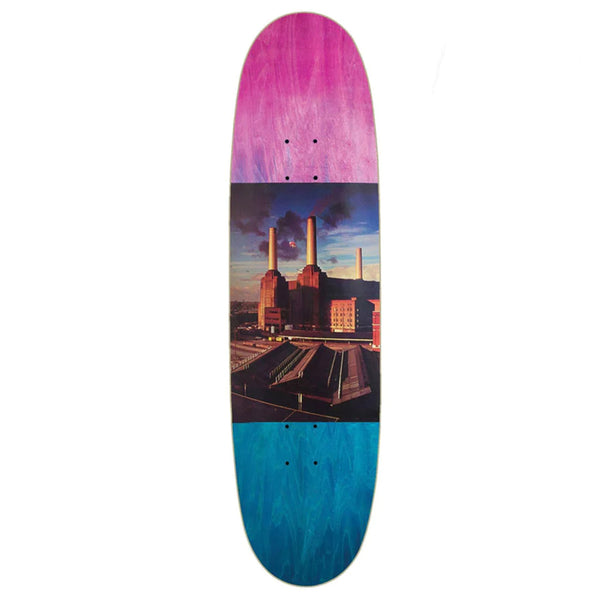 A HABITAT X PINK FLOYD WISH YOU WERE HERE SHAPED skateboard deck featuring a purple to blue gradient and a central image of an industrial building with smokestacks, inspired by the DARK SIDE OF THE MOON.