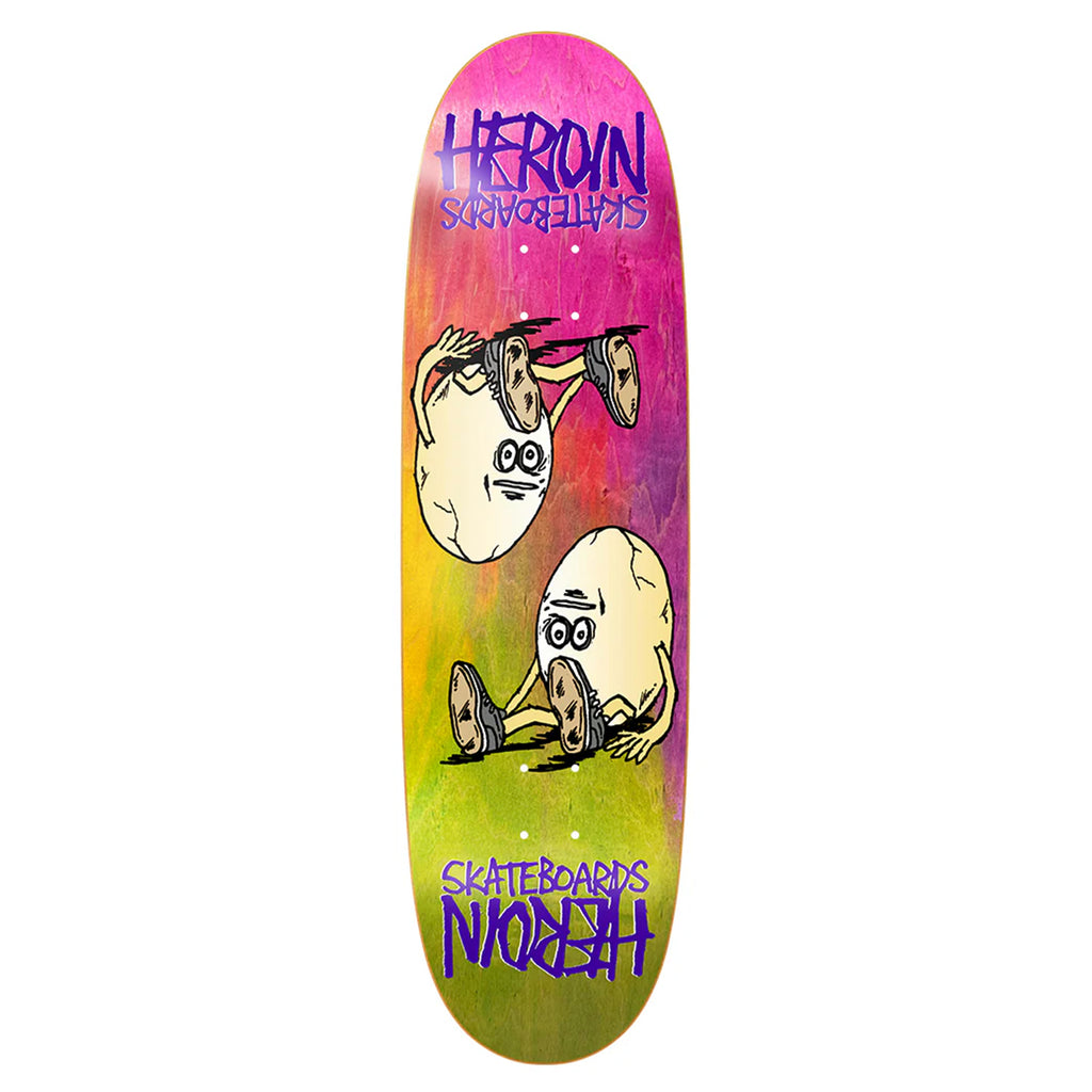 Introducing the HEROIN SYMMETRICAL EGG RAINBOW skateboard deck, crafted from North American Hard Rock Maple. It features a vibrant gradient background with two cartoon eggs sporting legs and shoes. The “HEROIN SKATEBOARDS” branding appears above and below the artwork, and it includes black grip tape.