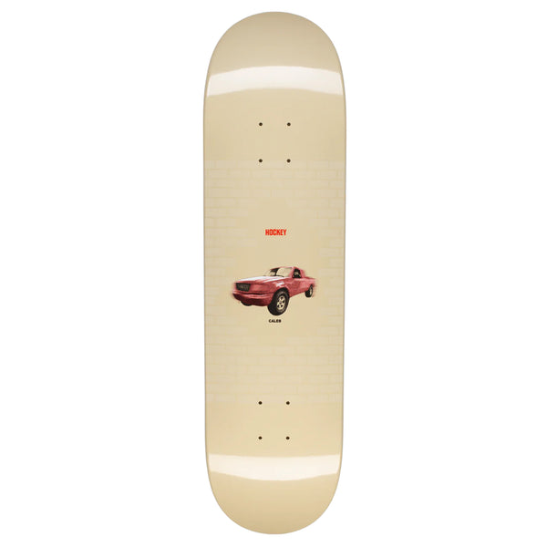 A HOCKEY skateboard with an image of a car on it.