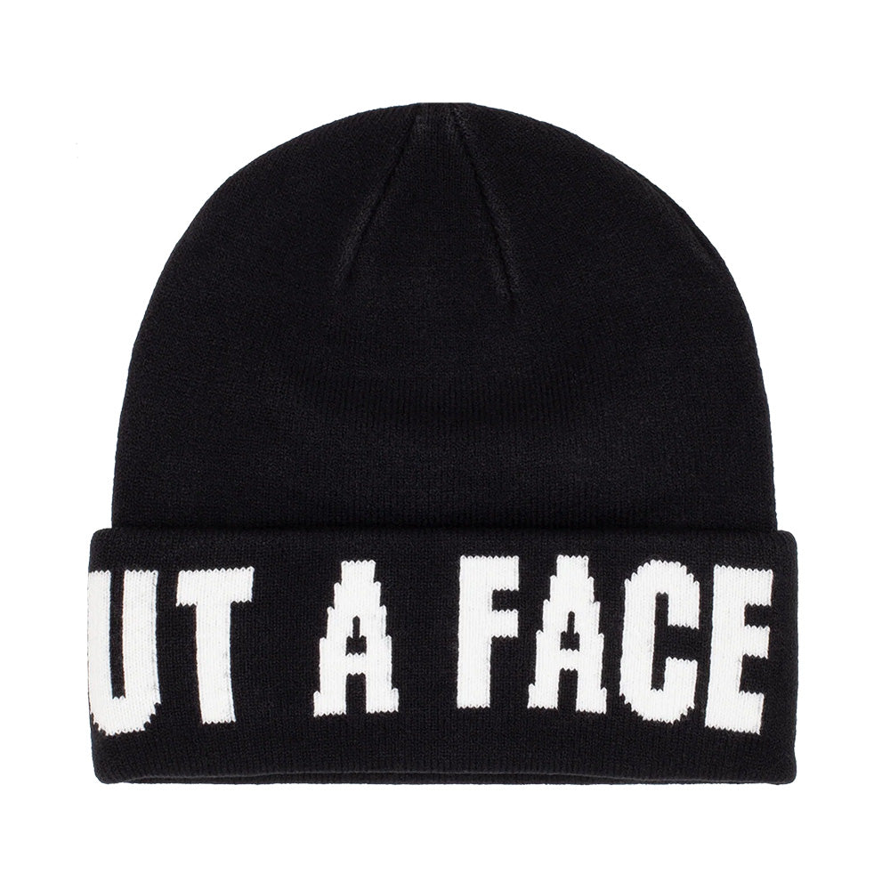 The HOCKEY SKI MASK BEANIE BLACK displays the partial phrase "UT A FACE" in bold white letters on its cuff, offering a sporty charm similar to a hockey team's style.