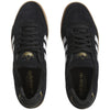 A pair of black and gold ADIDAS TYSHAWN LOW BLACK / WHITE / GUM sneakers.
