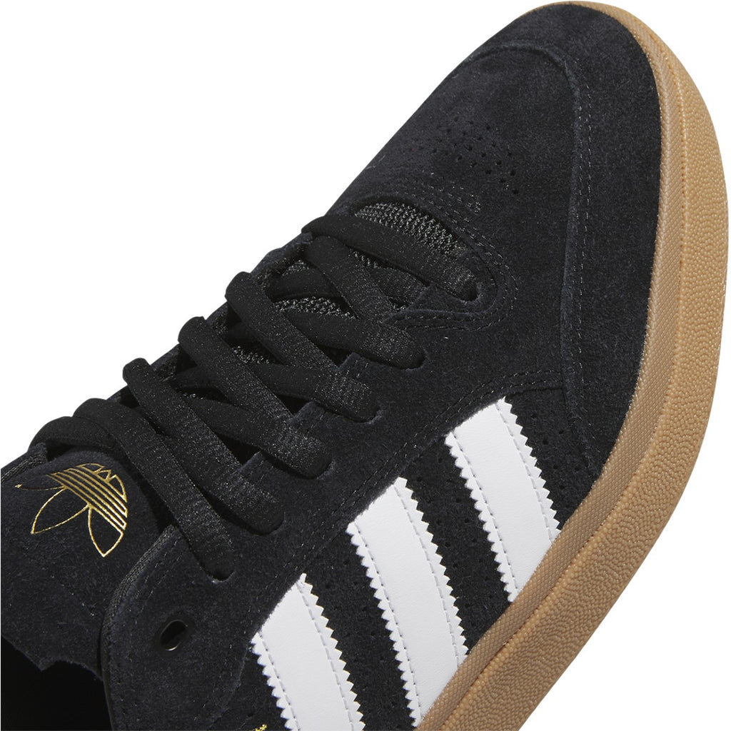 A black and white ADIDAS TYSHAWN LOW skate shoe with gum soles.