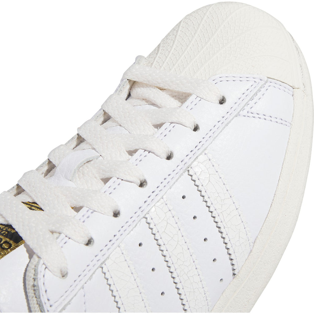 The ADIDAS SUPERSTAR ADV WHITE / WHITE sneakers are white and gold.