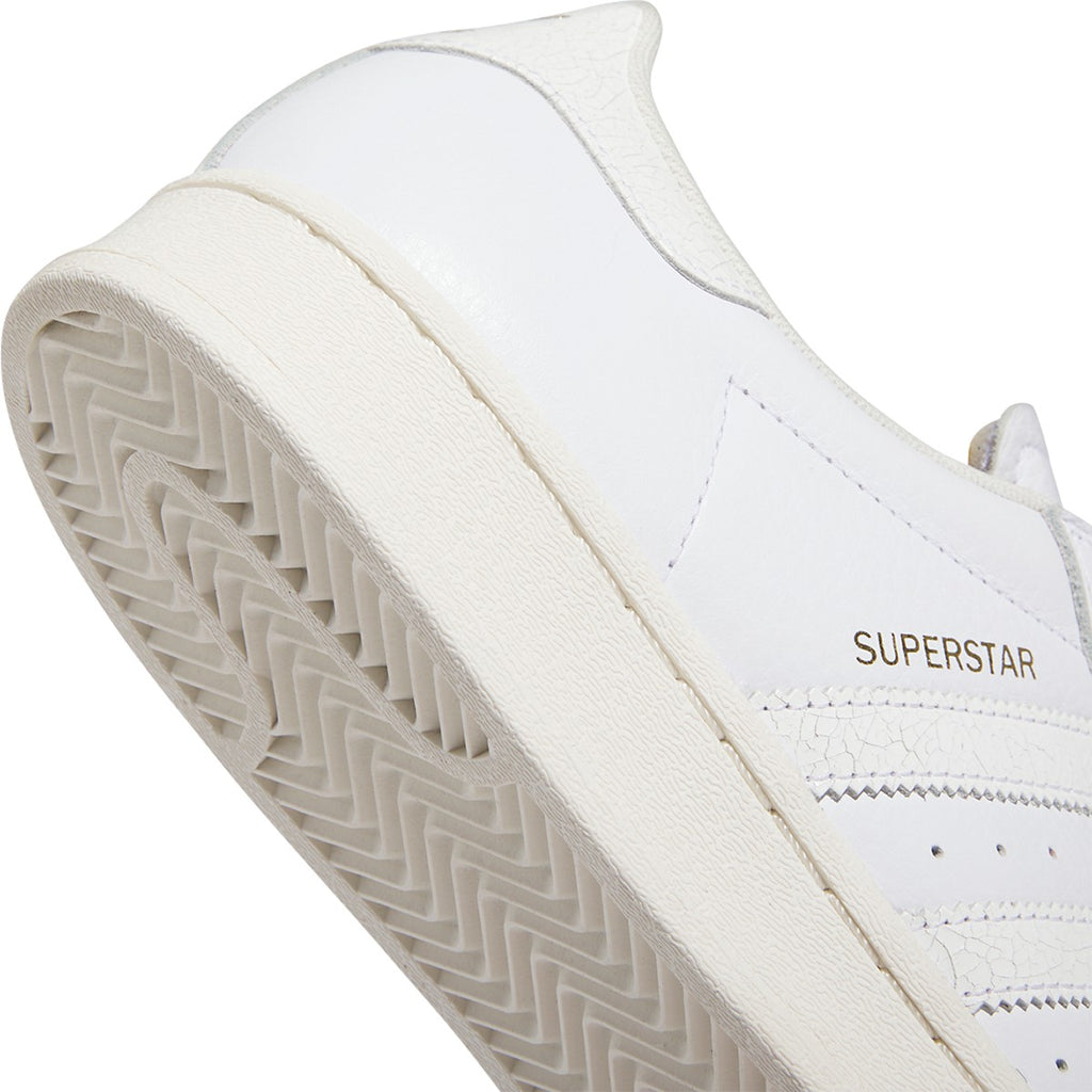 ADIDAS SUPERSTAR ADV trainers in white and gold.