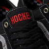 A black and red VANS X HOCKEY SKATE OLD SKOOL BLACK SNAKE SKIN shoe with the word hockey on it.