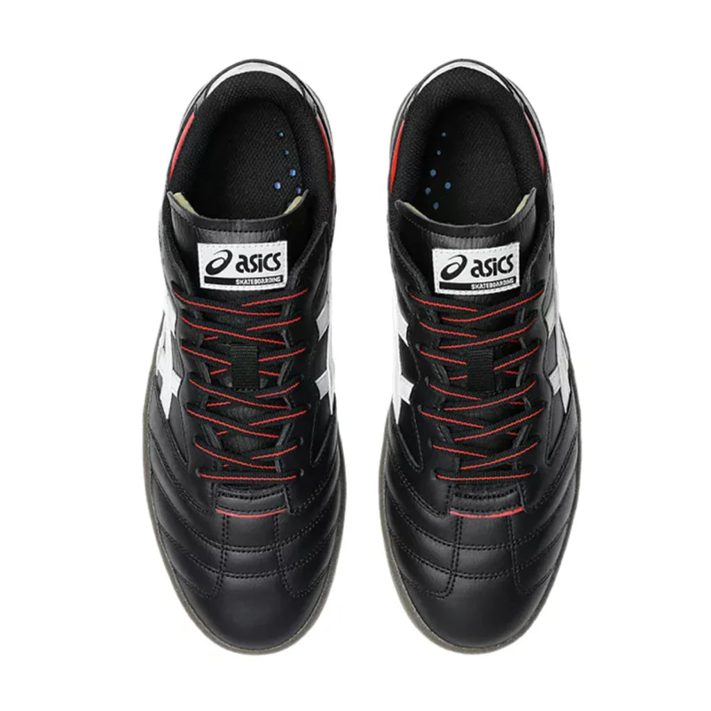 Top view of ASICS LEGGEREZZA FB BLACK / WHITE soccer cleats, featuring black leather with white logos and red lace accents, shown side by side on a white background.