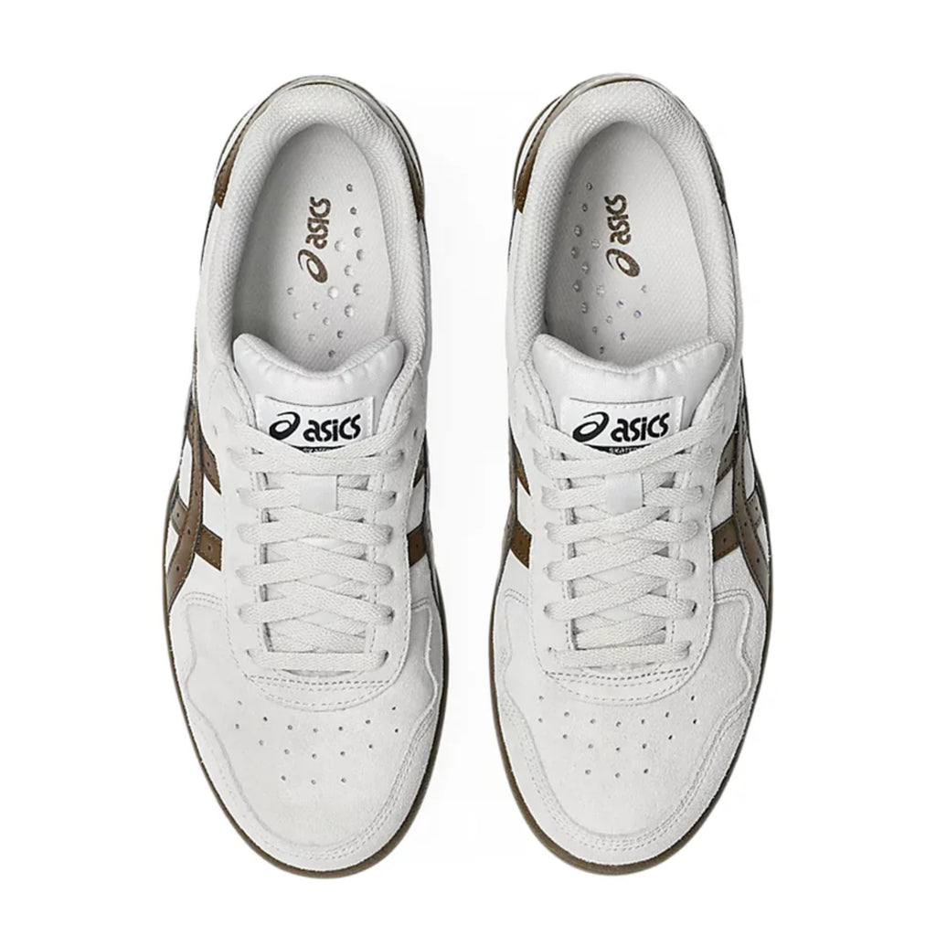 A pair of ASICS JAPAN PRO sneakers in Cloud Grey and Brown Storm, viewed from above, highlights the white laces, perforated toe area, and visible ASICS logos on the tongues and insoles.