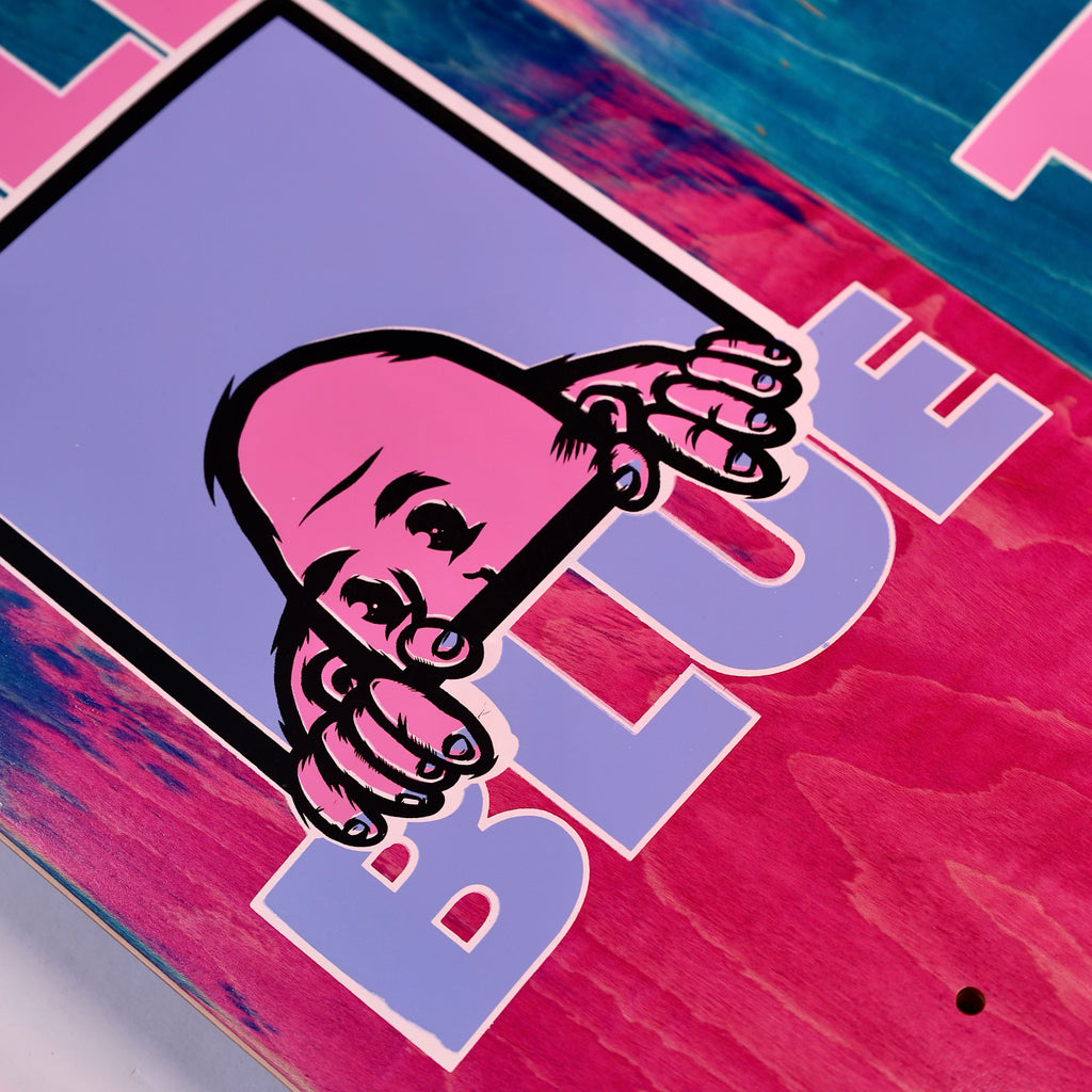 A graphic of a person peeking over a ledge is printed on the colorful BLUETILE W.T.F. DECK, crafted by Bluetile Skateboards, with the word "BLUE" partially visible below the Jay Croft artwork.