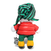 The Butter Goods BUTTER X PEANUTS JOE GRUNGE PLUSH is a polyester toy dressed in a red puffer jacket, green pants, yellow shoes, and a green-striped headscarf, holding a "Butter" key chain and facing away from the camera.