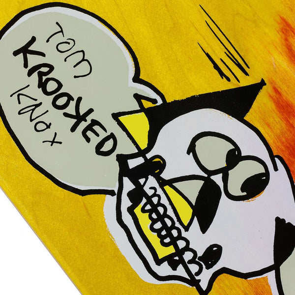 A vibrant depiction of a stylized skull features a speech bubble saying "Tom Krooked Knox" against a yellow backdrop, evoking the edgy aesthetics of skateboard art, reflected in the KROOKED KNOX BURN BIRD by KROOKED.