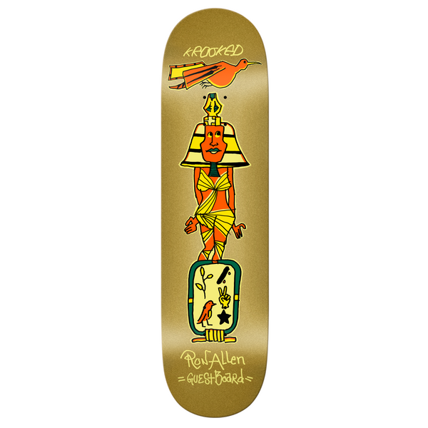 A gold colored skateboard with a print of a orange pharaoh and hieroglyphics.