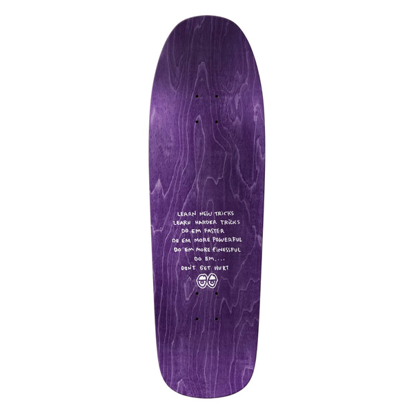 The KROOKED SANDOVAL PEACE SIGN skateboard deck by KROOKED features a purple, wood-grain finish, white motivational text at the center, and two small cartoon faces—one with a peace sign—near the bottom.