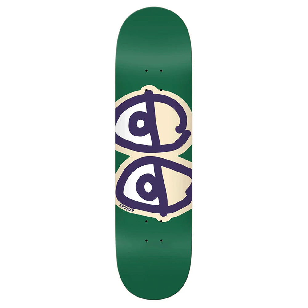 The KROOKED TEAM EYES GREEN skateboard deck by KROOKED features two stylized eyes with black outlines set on a beige and orange background at the center.