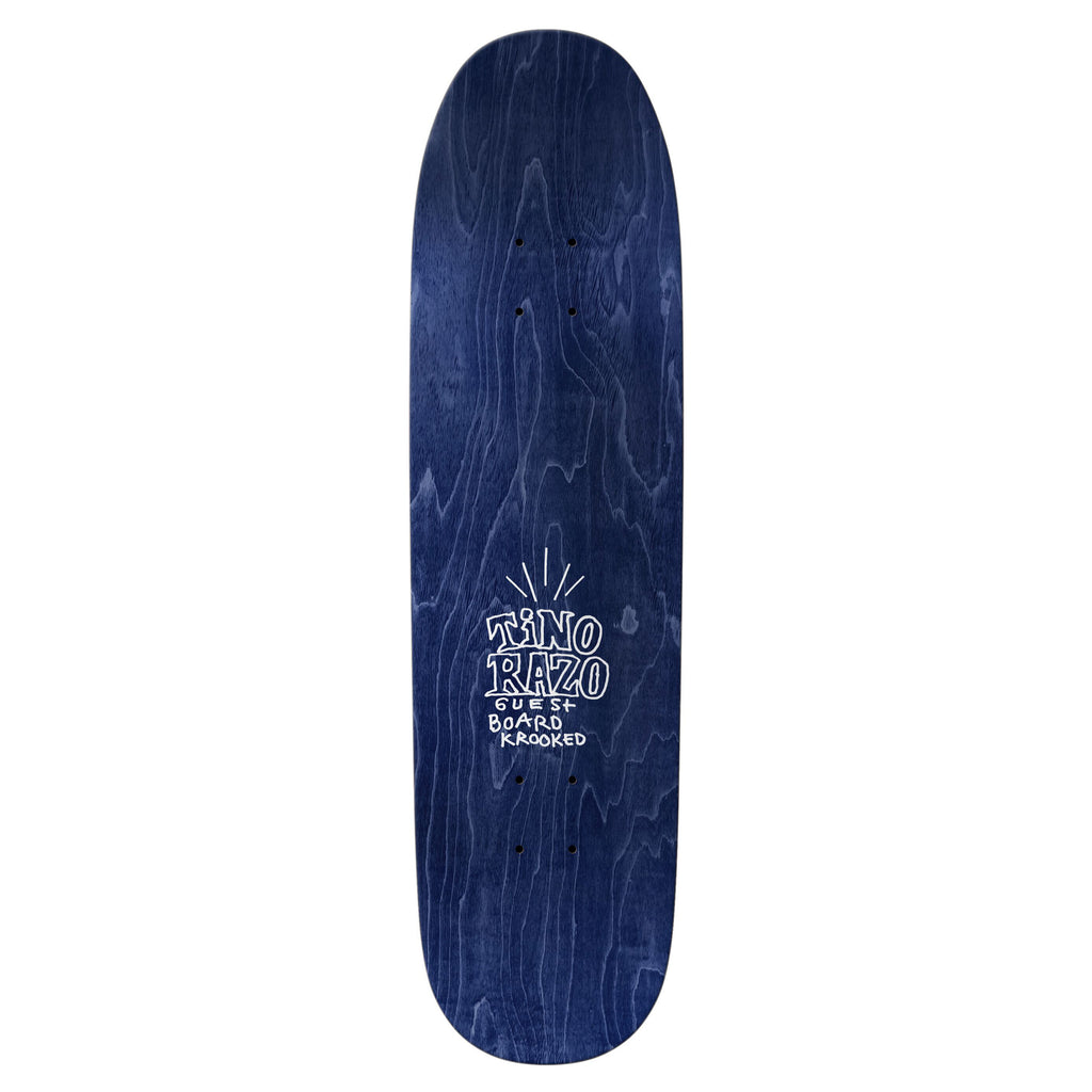 Blue skateboard deck with the product name "KROOKED TINO RAZO GUEST BOARD" printed in white on the lower half, featuring a design from guest artist Lee Smith.