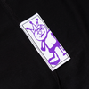 Clothing label with a purple hand screen printed doodle of a whimsical character on a white background, sewn onto Carpet Co.'s "Kid" Tee Black fabric.