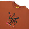 Close-up of a rust-colored Carpet Co. "Kid" tee featuring a hand screen printed graphic of a crown on top of a squiggly face, with "brat f.i.l.u.b" by Carpet Company logo