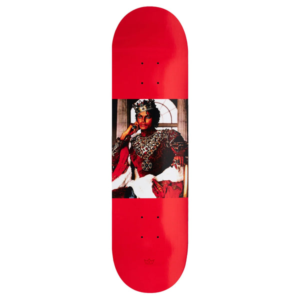 A red skateboard with a picture of a king, specifically King Tyshawn Jones, on it.