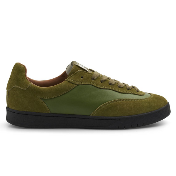 A green shoe with leader mid paneling and suede paneling around it, and a rubber black sole.