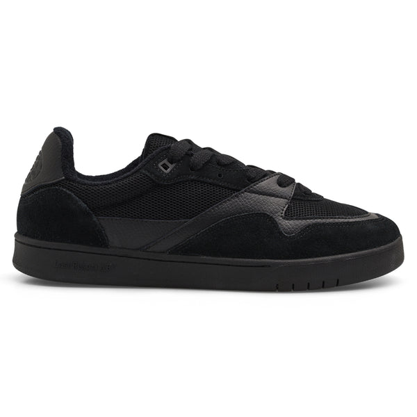 Incorporating suede and mesh, the LAST RESORT AB CM002 BLACK / BLACK offers a side view of a black sneaker equipped with laces and a flat rubber sole. This stylish model from Last Resort AB enhances any casual outfit with its sleek design.