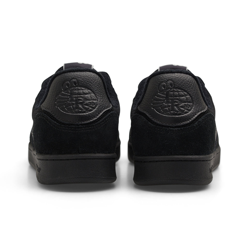 Rear view of the Last Resort AB CM002 black/black leather sneakers with a cartoon face embossed on the heel tabs.