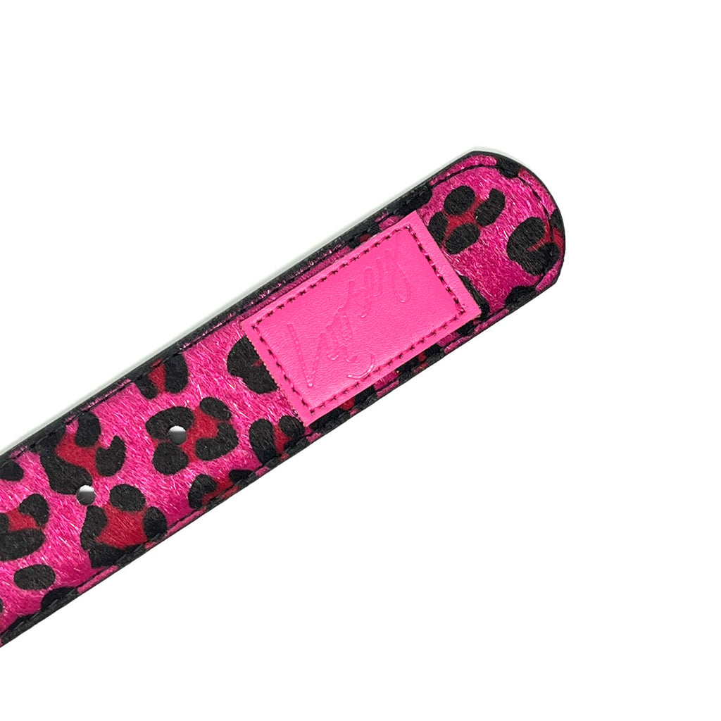 A Loosey pink and black leather case with a leopard print that features gold details.