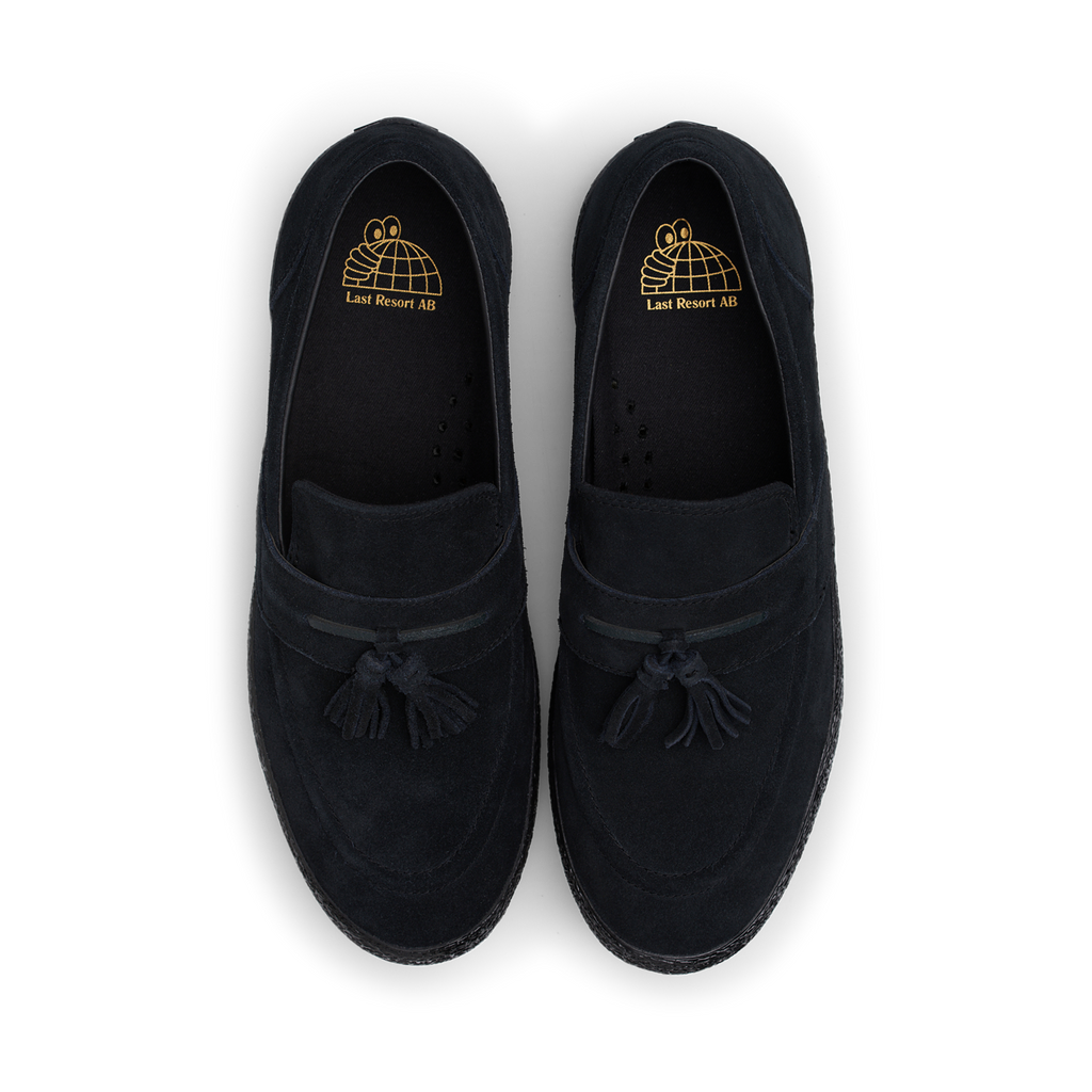 A pair of LAST RESORT AB VM005 SUEDE BLACK / BLACK loafers with tassels featuring a suede upper and rubber sole by Last Resort AB.