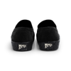 A pair of Last Resort AB black slip-on shoes with a suede upper and a logo on the side.