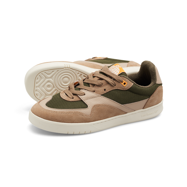 Introducing the LAST RESORT AB CM002 TACTILE GREEN by Last Resort AB: a pair of athletic sneakers in brown and green featuring white soles, mesh panels, and brown suede accents. These sleek sneakers are finished with black leather details for an enhanced sense of style.