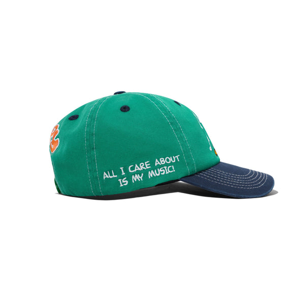 The Butter Goods BUTTER X PEANUTS MUSIC SNAPBACK CAP in washed kelly green/navy is a cotton twill snapback, with "ALL I CARE ABOUT IS MY MUSIC!" embroidered in white on the side.