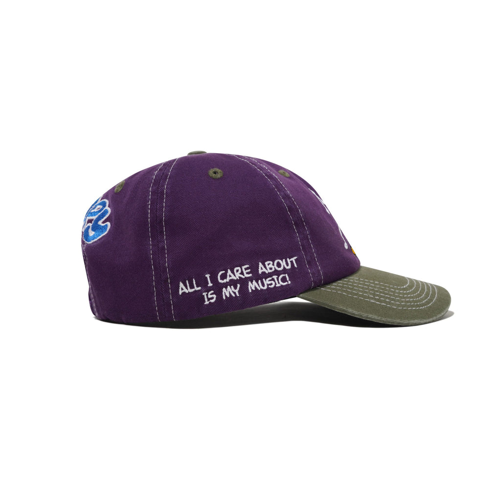 The Butter Goods BUTTER X PEANUTS MUSIC Snapback Cap in washed purple/fern features "ALL I CARE ABOUT IS MY MUSIC!" embroidered in white on the side.