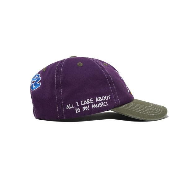 The Butter Goods BUTTER X PEANUTS MUSIC Snapback Cap in washed purple/fern features "ALL I CARE ABOUT IS MY MUSIC!" embroidered in white on the side.