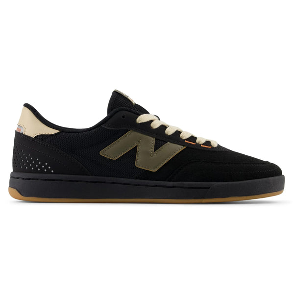 A black cupsole skate shoe with a beige "N" logo, beige and black accents, perforated heel, and gum-colored sole viewed from the side, ideal for the everyday skater and part of the NB NUMERIC NB NUMERIC 440 V2 BLACK / GREEN collection.