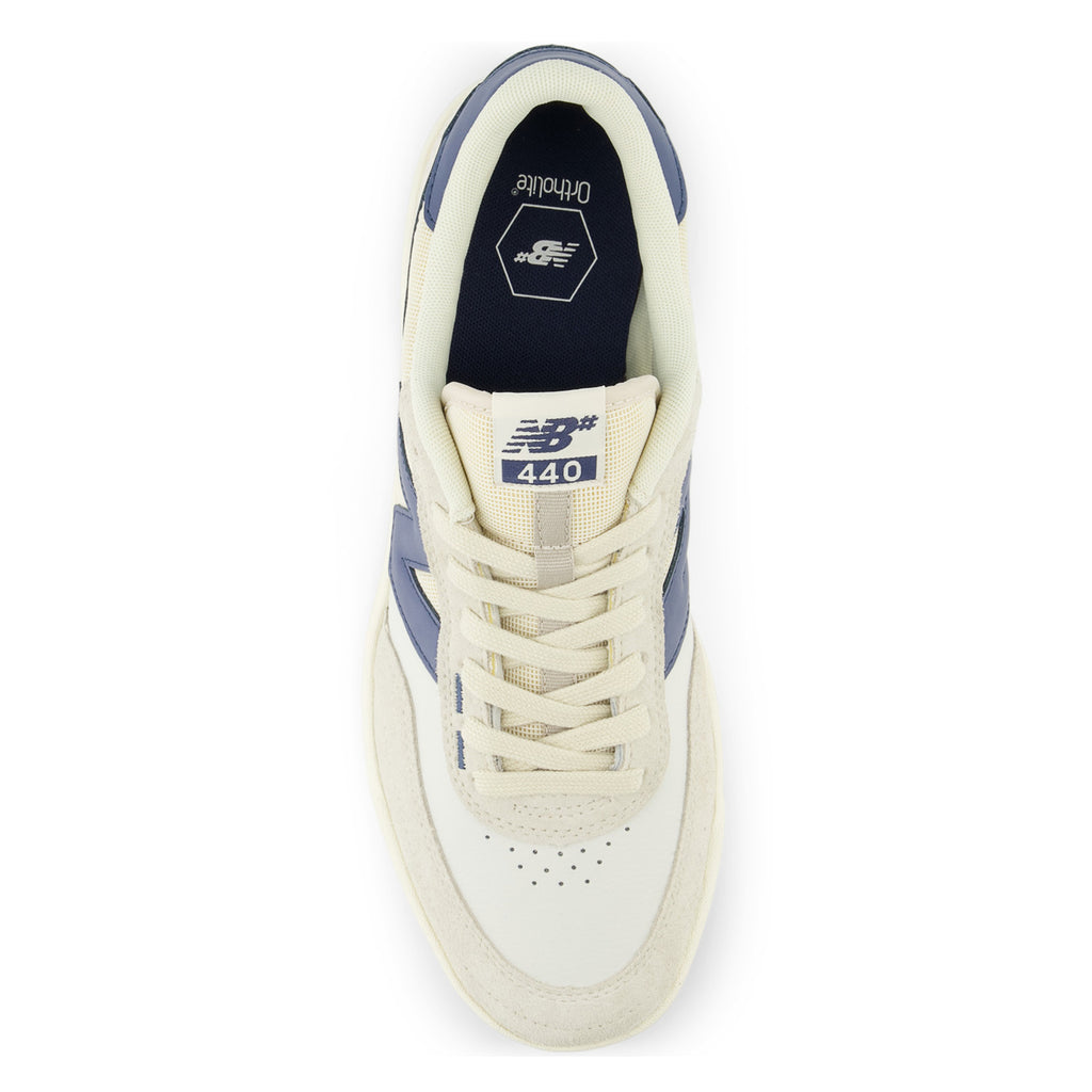A white and blue NB Numeric 440 V2 sneaker with a white sole.