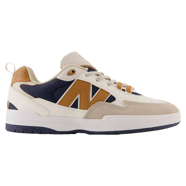 A NB NUMERIC 808 TIAGO WHITE / BROWN sneaker with a blue and brown stripe.