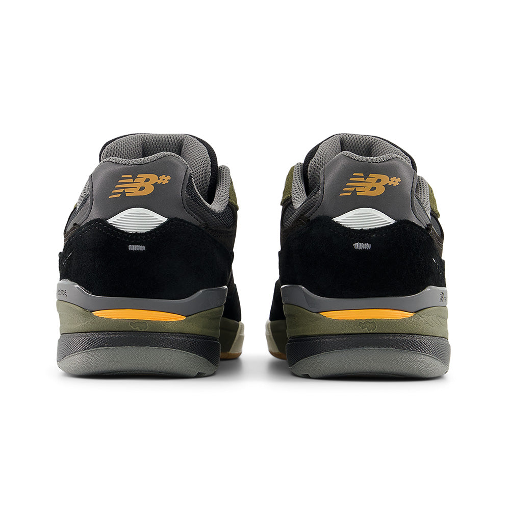 Rear view of NB NUMERIC REYNOLDS 933 sneakers in black and dark olivine with yellow accents, the NB Numeric logo on the heels, and responsive FuelCell foam for enhanced comfort.