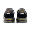 Rear view of NB NUMERIC REYNOLDS 933 sneakers in black and dark olivine with yellow accents, the NB Numeric logo on the heels, and responsive FuelCell foam for enhanced comfort.